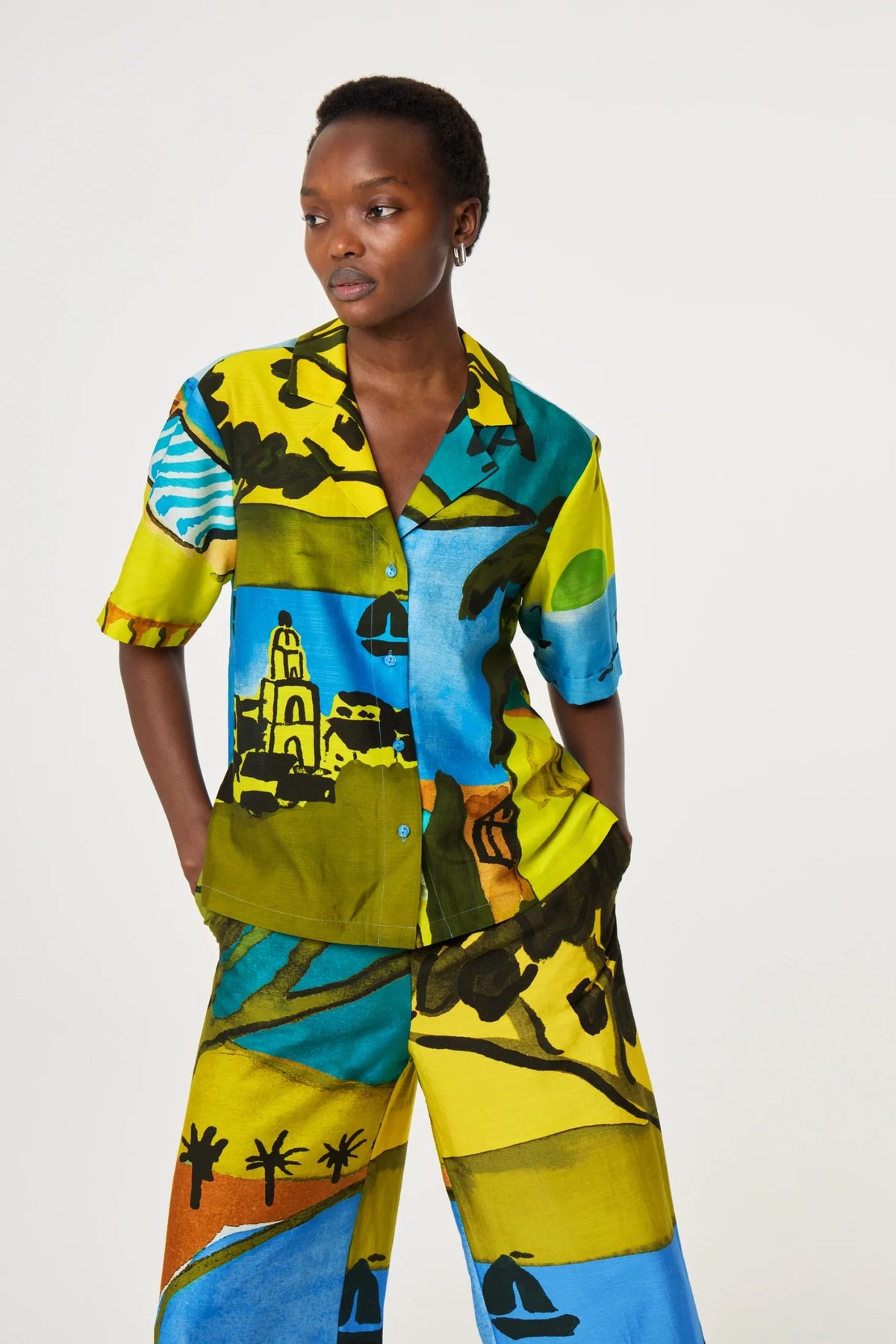 Person wearing a colorful outfit with abstract patterns on a white background