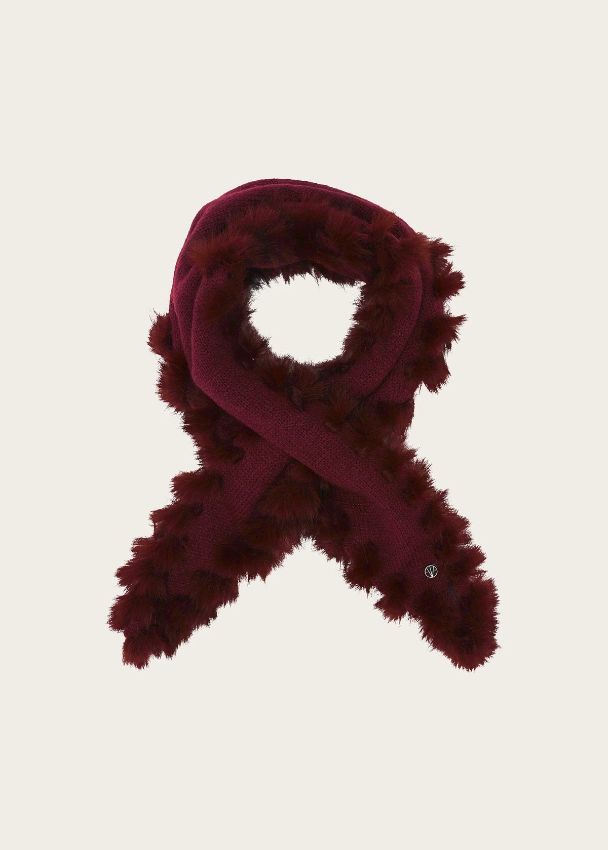 A dark burgundy faux fur scarf with a solid burgundy inner lining, arranged in a loop and cross-over style against a light beige background.