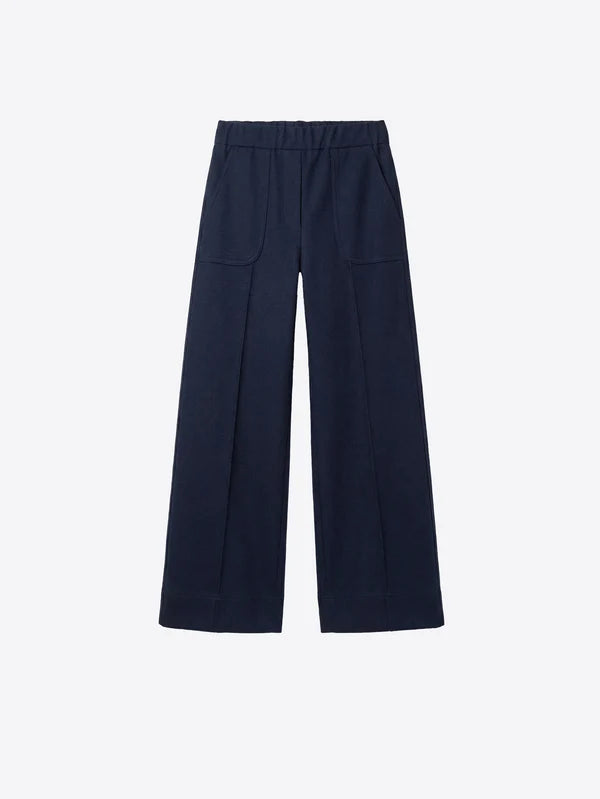 A pair of dark navy blue wide-leg trousers with a flat front and side pockets, displayed flat against a light gray background.